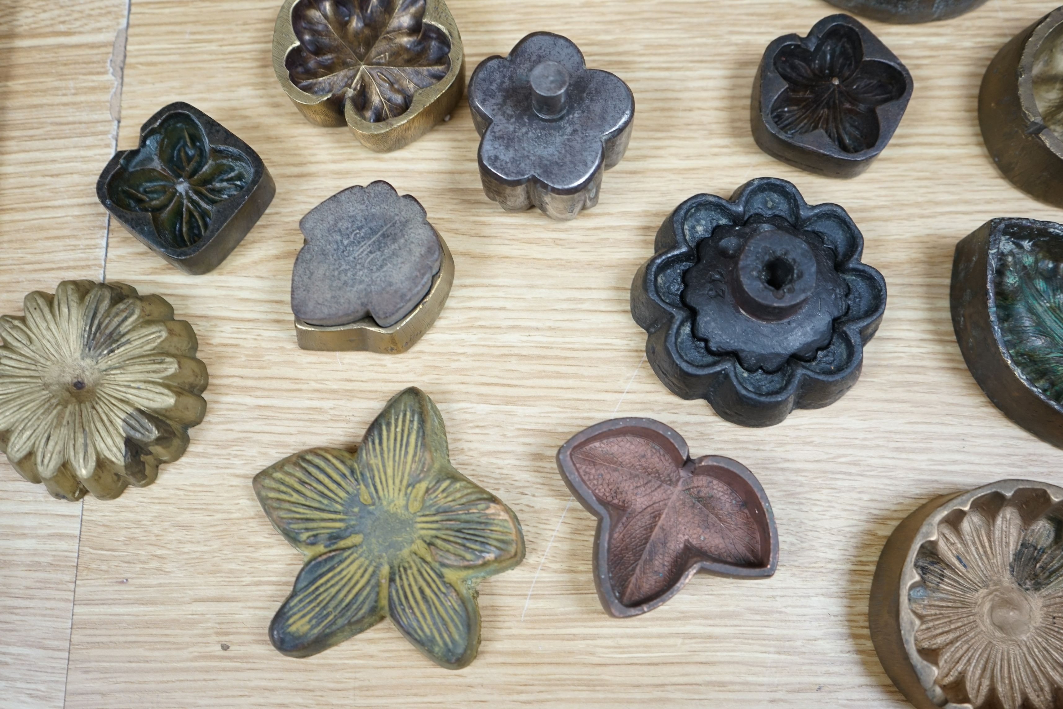 A collection of metal pattern moulds possibly for embossing silk (19) and two other moulds